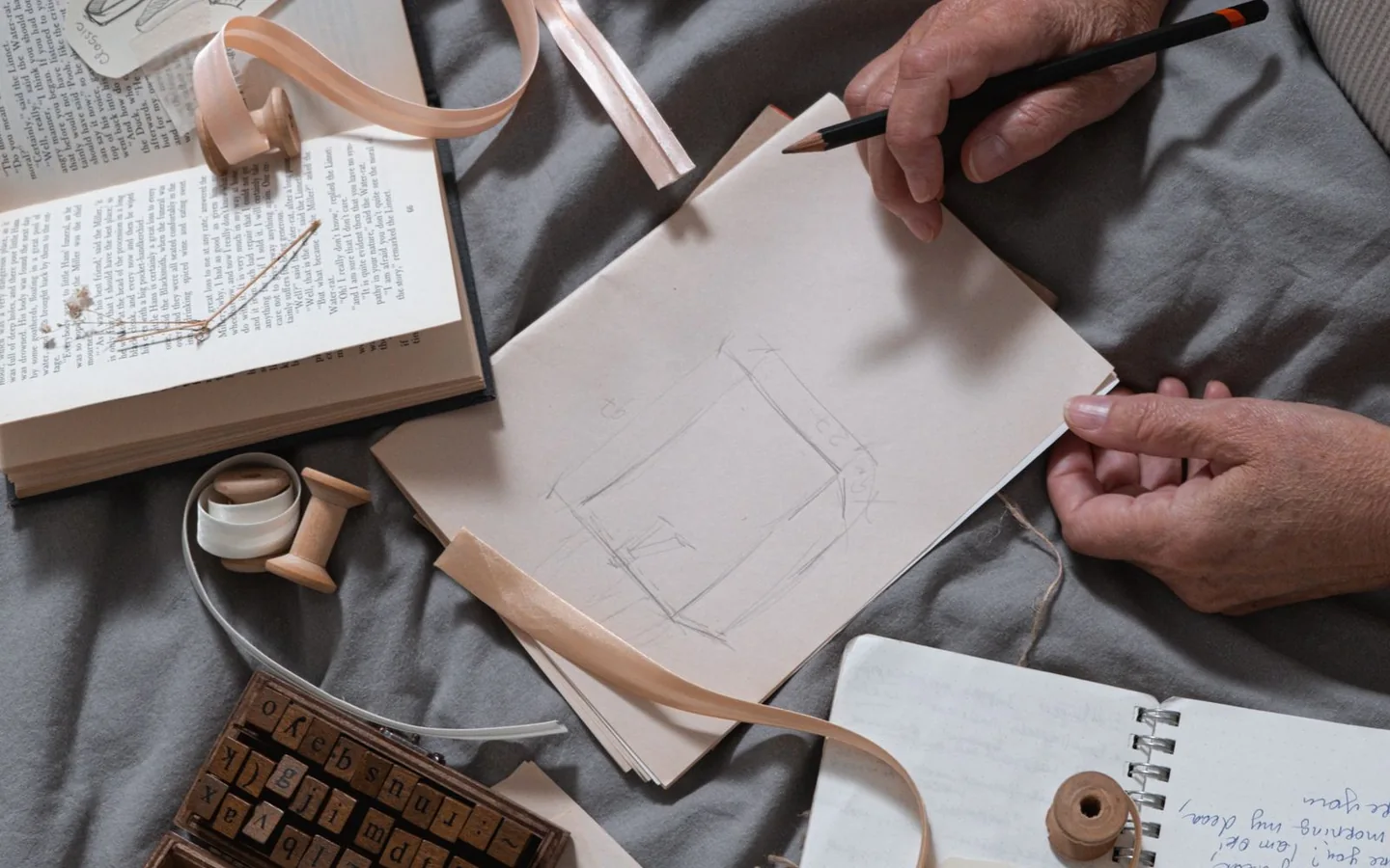 An overhead composition of sketching materials and creative stationery