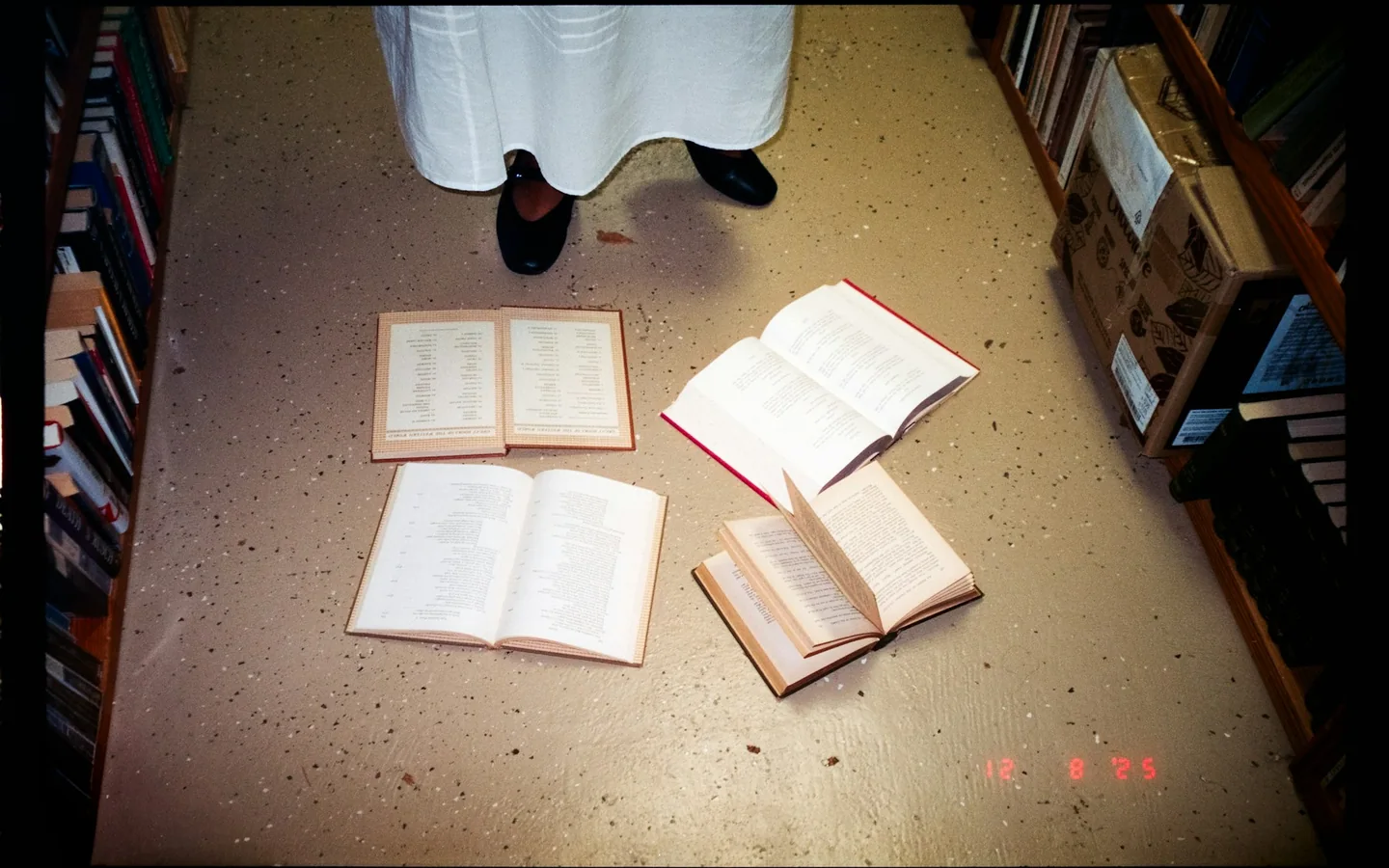 Open books arranged across a floor